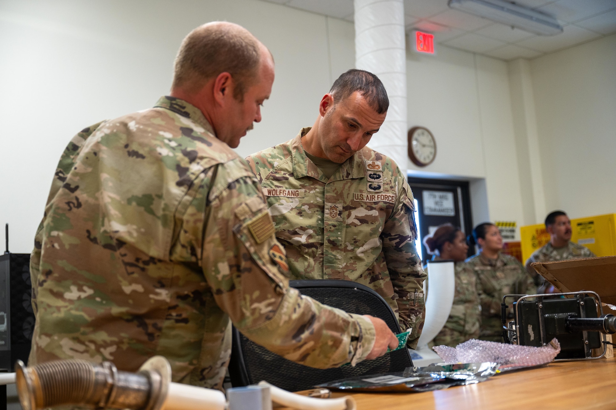 U.S. Air Force Chief Master Sgt. Brandon Wolfgang, Eighth Air Force command chief and Joint-Global Strike Operations Center senior enlisted leader, observes a circuit board repaired by the 7th Equipment Maintenance Squadron during a base tour at Dyess Air Force Base, Texas, Sept. 3, 2025. Wolfgang gained a firsthand look at the infrastructure and resources that support Team Dyess’s mission. (U.S. Air Force photo by Airman 1st Class Adrien Tran)