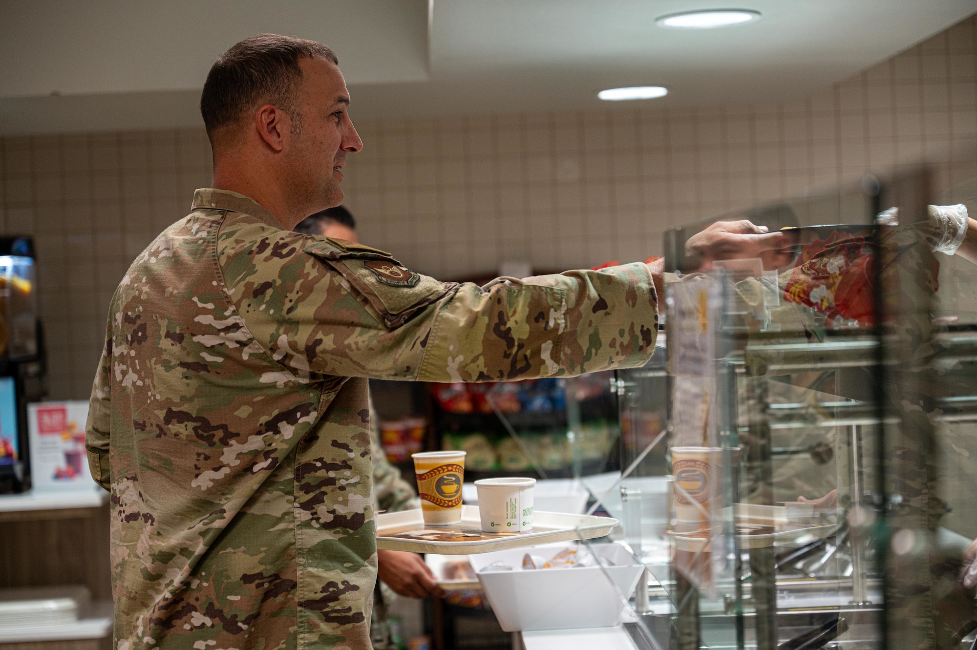U.S. Air Force Chief Master Sgt. Brandon Wolfgang, Eighth Air Force command chief and Joint-Global Strike Operations Center senior enlisted leader, prepares to eat breakfast at the Longhorn Dining Facility during a base tour at Dyess Air Force Base, Texas, Sept. 3, 2025. Wolfgang visited various units and met with Airmen at Dyess that support the 8th AF mission. (U.S. Air Force photo by Airman 1st Class Adrien Tran)