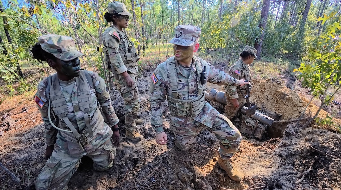 U.S. Army Reserve Drill Sergeant Staff Sgt. Christopher Trueblood, assigned to 4th Battalion, 39th Infantry Regiment, mentors trainees during “The Forge” at Fort Jackson, South Carolina, Aug. 27, 2025. The Forge is the culminating field training exercise of Basic Combat Training, testing everything trainees have learned before graduation. (U.S. Army Reserve photo by Lt. Col. Xeriqua Garfinkel)