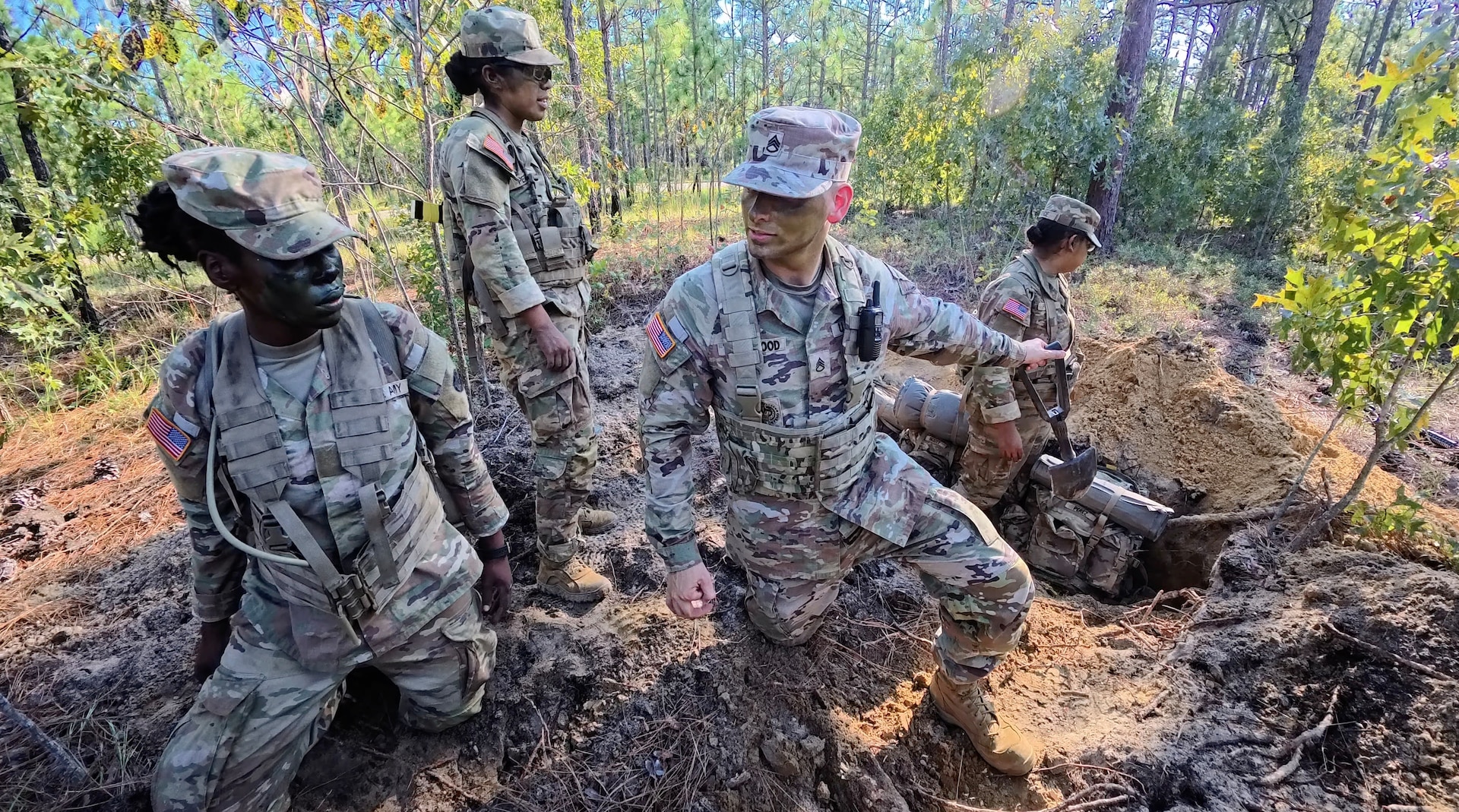 U.S. Army Reserve Drill Sergeant Staff Sgt. Christopher Trueblood, assigned to 4th Battalion, 39th Infantry Regiment, mentors trainees during “The Forge” at Fort Jackson, South Carolina, Aug. 27, 2025. The Forge is the culminating field training exercise of Basic Combat Training, testing everything trainees have learned before graduation. (U.S. Army Reserve photo by Lt. Col. Xeriqua Garfinkel)