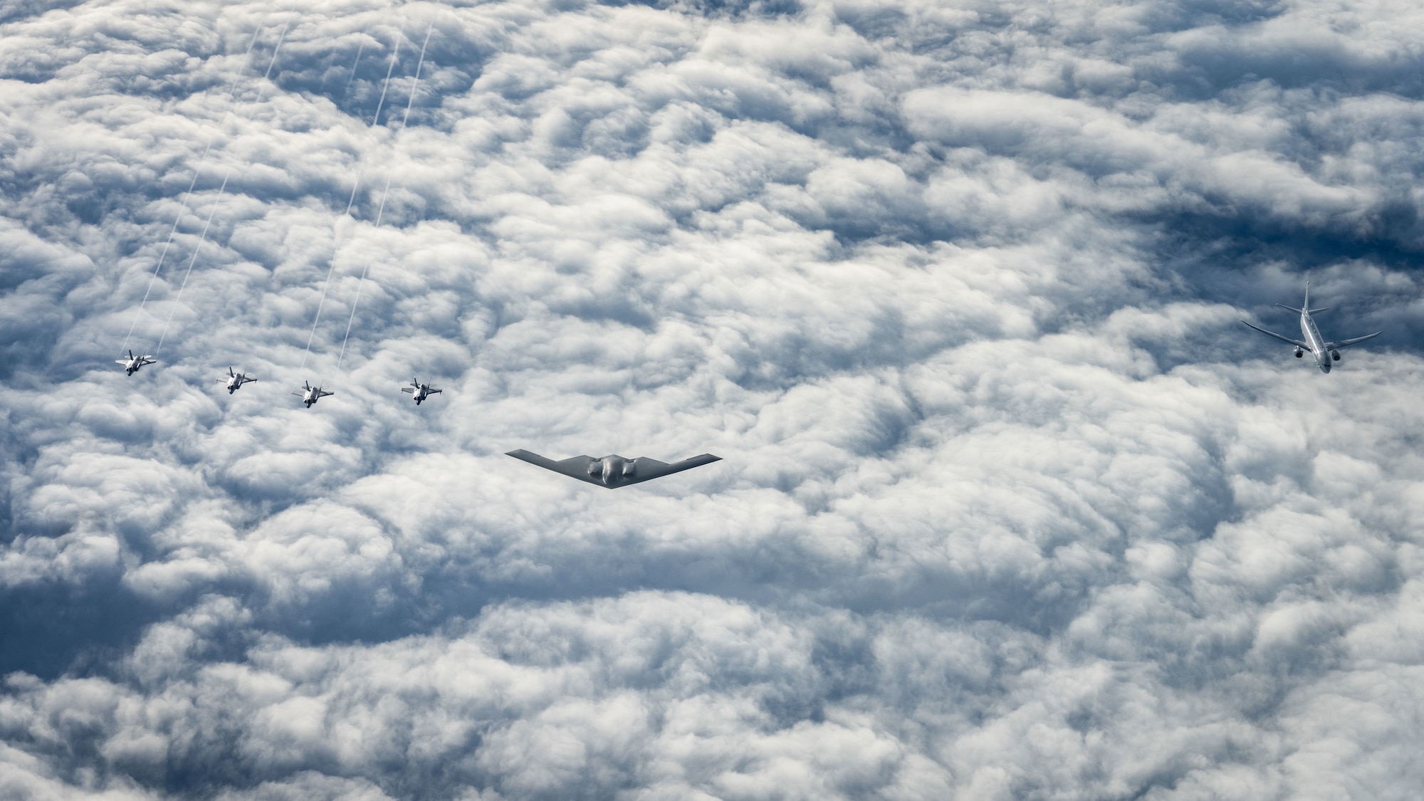 A U.S. Air Force B-2 Spirit, center, from the 53rd Wing, Eglin Air Force Base, a U.S. Navy P-8 Poseidon, right, and four Royal Norwegian Air Force F-35 Lightning II, left, fly in formation over Norway, Sept. 3, 2025. The U.S. partnered with Norwegian Allies to test next-generation precision maritime strike capabilities. The event advanced tactics, techniques, and procedures for long-range sensor-to-shooter operations. (U.S. Air Force Photo by Tech. Sgt. Jesenia Landaverde)