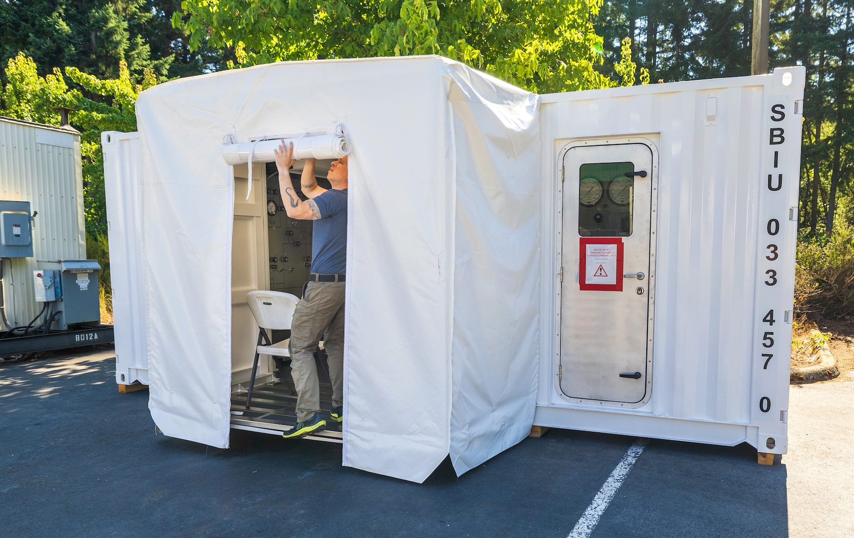 Navy Diver 1st Class Josh Amberson prepares the Bangor Dive Locker's new transportable Hyperbaric Chamber on Naval Base Kitsap-Bangor, Washington, July 29, 2025. (U.S. Navy photo by Wendy Hallmark)