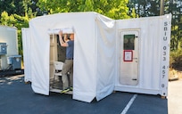 Navy Diver 1st Class Josh Amberson prepares the Bangor Dive Locker's new transportable Hyperbaric Chamber on Naval Base Kitsap-Bangor, Washington, July 29, 2025. (U.S. Navy photo by Wendy Hallmark)