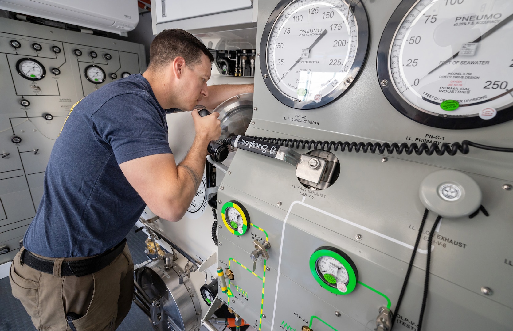 Diver 1st Class Josh Amberson communicates with divers inside the new hyperbaric chamber July 29, 2025, during a simulated emergency at Naval Base Kitsap-Bangor, Washington. (U.S. Navy photo by Wendy Hallmark)