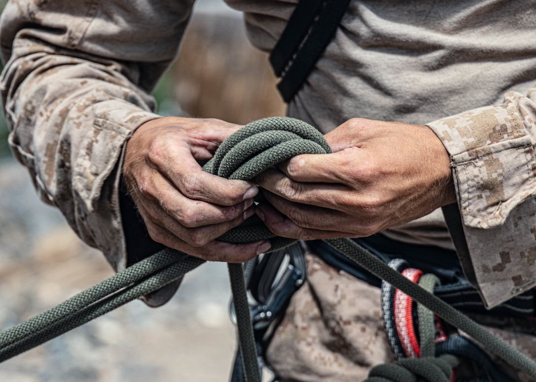 U.S. Marine Corps Cpl. Brendon Hall, a rifleman with 3rd Battalion, 5th Marine Regiment, 1st Marine Division, I Marine Expeditionary Force, ties a knot during Assault Climbers Course 25-3 at Marine Corps Mountain Warfare Training Center Bridgeport, California, Aug. 22, 2025.