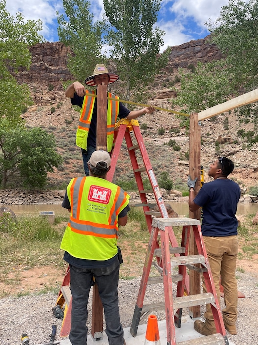 The maintenance crew at Abiquiu Lake practice safe ladder use while building the Wave Changing Station in the Rio Chama Recreation Area, June 26, 2024. Photo by Pamela Bowie.