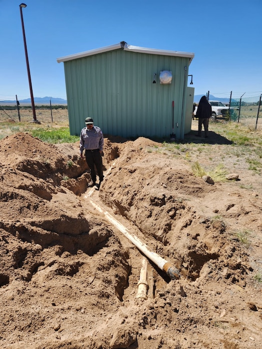 Park Ranger Wayne Arquero investigates a water leak along the water supply line to the Tetilla Campground at Cochiti Lake, May 2025. Photo by Samantha Jones.
