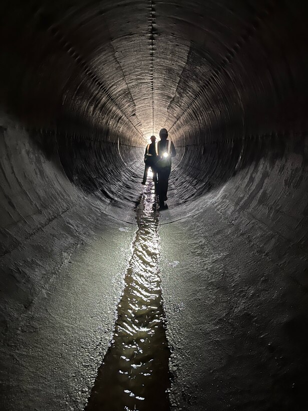 Two Albuquerque District employees conduct the annual inspection on the Galisteo Dam conduit, May 8, 2025.