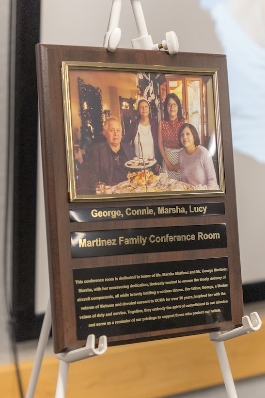 A plaque of a smiling family is displayed on a stand