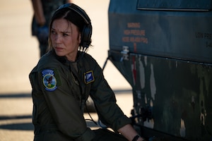 U.S. Air Force Tech. Sgt. Emily Knight, an instructor loadmaster assigned to the 130th Airlift Squadron, hooks up a chain to cargo to be loaded onto a C-130J Super Hercules aircraft at Komatsu Airport, Japan, July 29, 2025, during Exercise Resolute Force Pacific 2025. Air Mobility Command aircraft provide critical airlift and air refueling capabilities to project, connect, maneuver, and sustain the Joint Force during the REFORPAC and the first-in-a-generation Department-Level Exercise series. The DLE series encompasses all branches of the Department of Defense, along with Allies and partners, employing more than 400 Joint and coalition aircraft and more than 12,000 members at more than 50 locations across 3,000 miles. (U.S. Air Force photo by Tech. Sgt. Nicholas Monteleone)