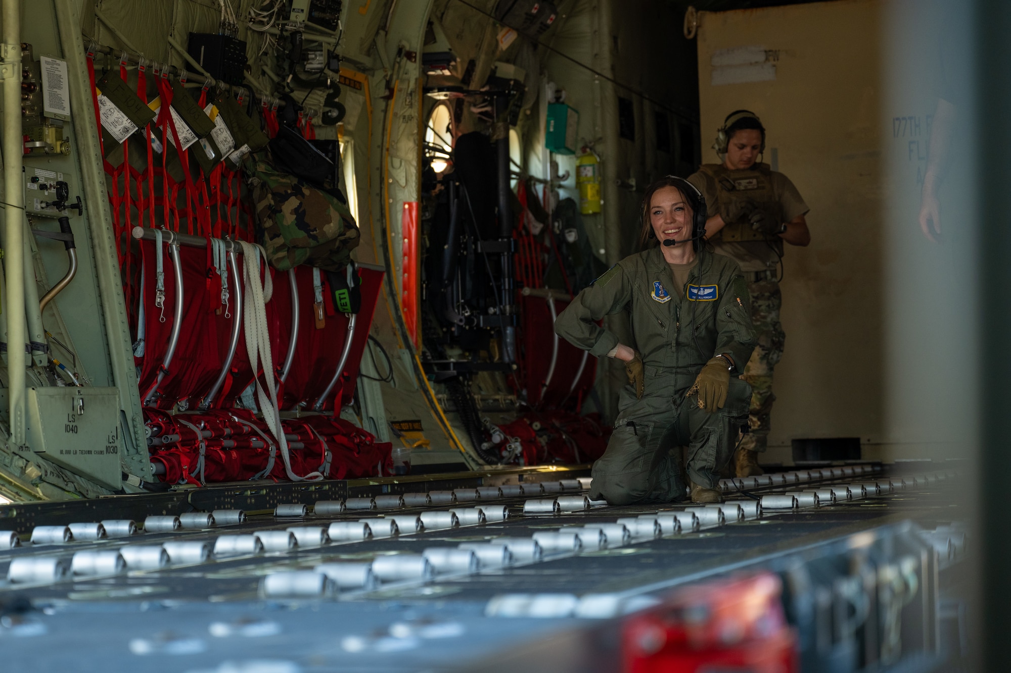 U.S. Air Force Tech. Sgt. Emily Knight, an instructor loadmaster with the 130th Airlift Squadron, waits for the next pallet of cargo to be loaded on a C-130J Super Hercules aircraft at Komatsu Airport, Japan, July 29, 2025, during Exercise Resolute Force Pacific 2025. Air Mobility Command aircraft provide critical airlift and air refueling capabilities to project, connect, maneuver, and sustain the Joint Force during the REFORPAC and the first-in-a-generation Department-Level Exercise series. The DLE series encompasses all branches of the Department of Defense, along with Allies and partners, employing more than 400 Joint and coalition aircraft and more than 12,000 members at more than 50 locations across 3,000 miles. (U.S. Air Force photo by Tech. Sgt. Nicholas Monteleone)