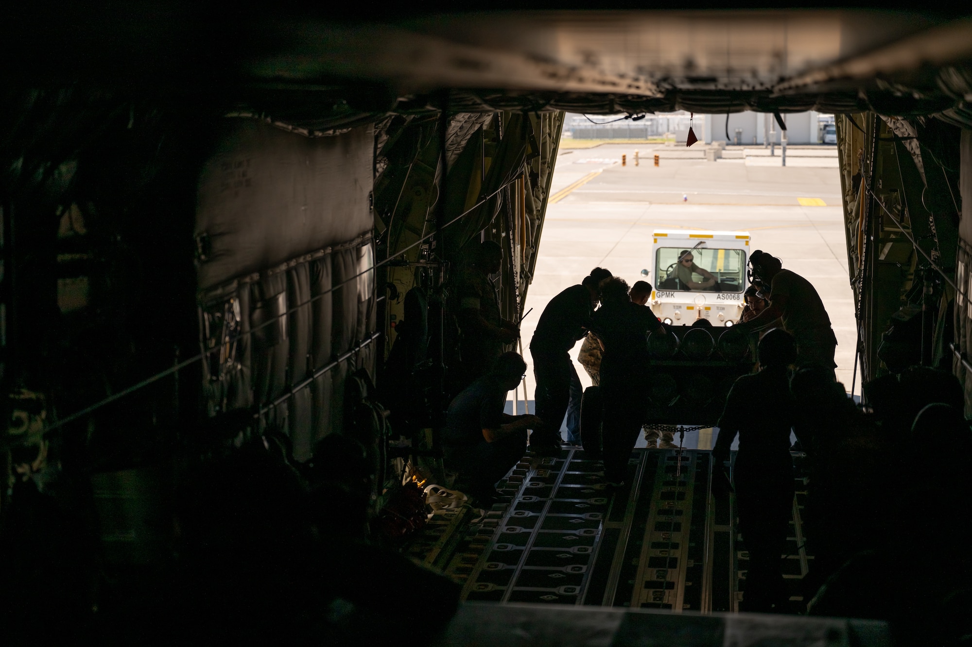 Loadmasters and ground crew offload rolling stock from a C-130J Super Hercules aircraft at Marine Corps Air Station Iwakuni, Japan, July 29, 2025. Air Mobility Command aircraft enable local, routine training and operations to deliver rapid global mobility, ensuring U.S. and Allied forces can project power and respond swiftly anywhere in the world. With a fleet of versatile aircraft, AMC provides the critical capability to transport personnel, equipment, and supplies when and where needed. (U.S. Air Force photo by Tech. Sgt. Nicholas Monteleone)