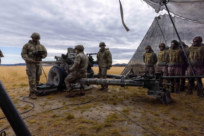 Soldiers assigned to 2nd Battalion, 8th Field Artillery Regiment, 1st Infantry Brigade Combat Team (Arctic), 11th Airborne Division conduct pre-fire checks on a M119 Howitzer as Indian Army soldiers observe at Yukon Training Area, Alaska, Sept. 6 2025 during Exercise Yudh Abhyas 25.