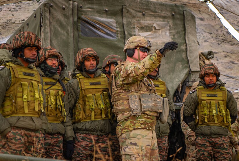 A U.S. Army Soldier from the 11th Airborne Division briefs Indian Army Soldiers before a live-fire training event during Exercise Yudh Abhyas 2025 at Yukon Training Area, Alaska, Sept. 2025. The training builds shared understanding and trust, strengthening the partnership between both nations’ armies.