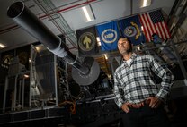 Engineer standing in front of flags in a lab