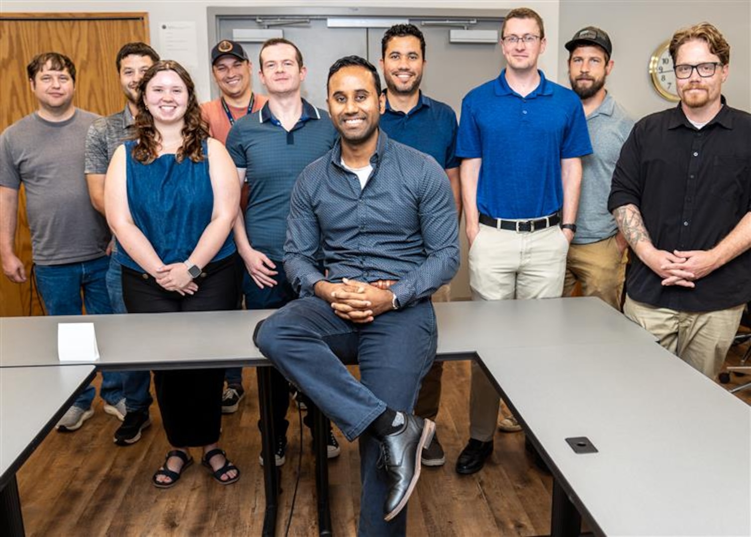 Engineers standing around a table in a lab