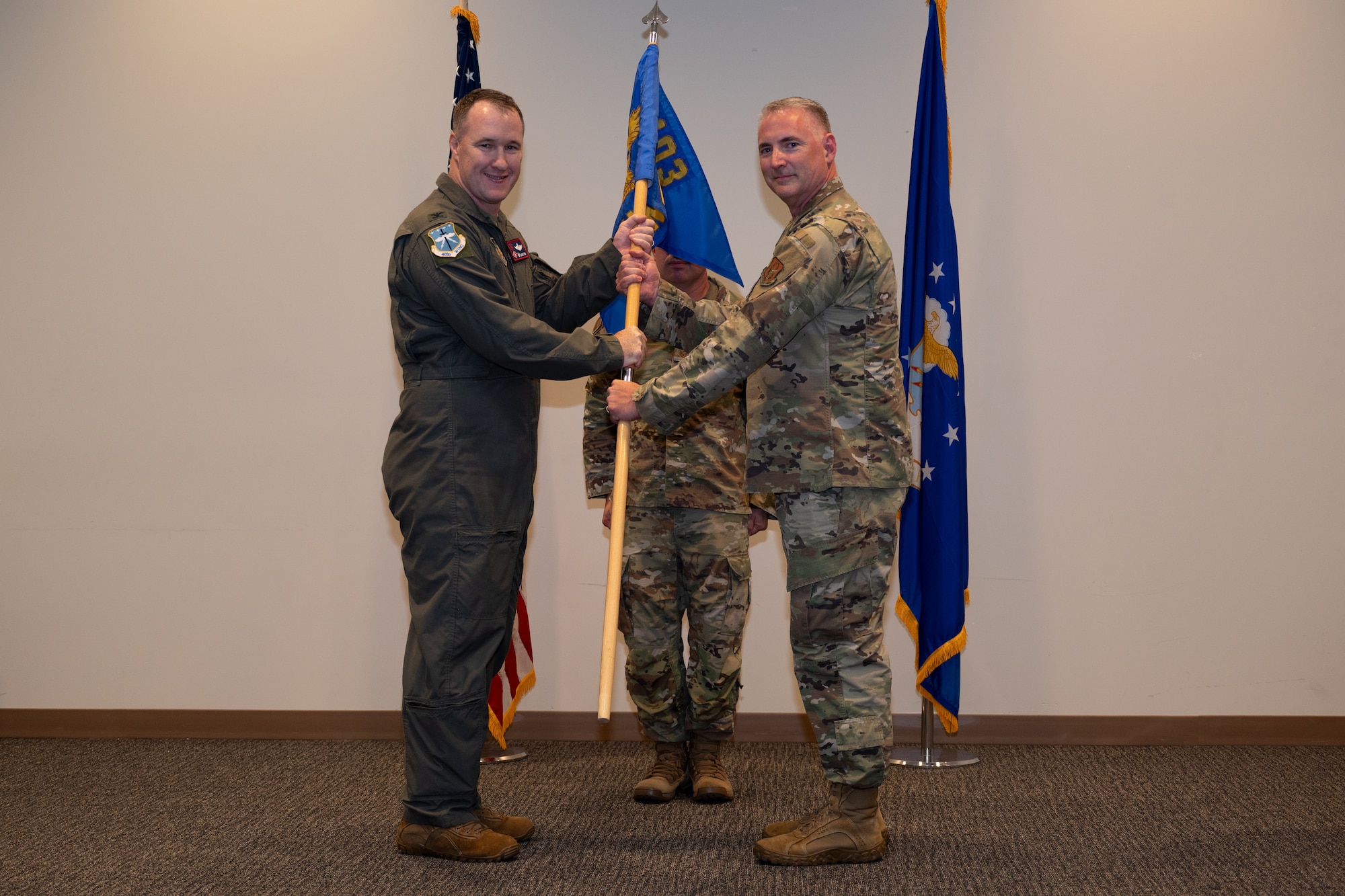 Chief Master Sgt. Tige “Tiger” Platt, incoming 403rd Wing command chief, receives the guidon from Col. Jaret Fish, 403rd Wing commander, during the wing’s first-ever Change of Responsibility ceremony.