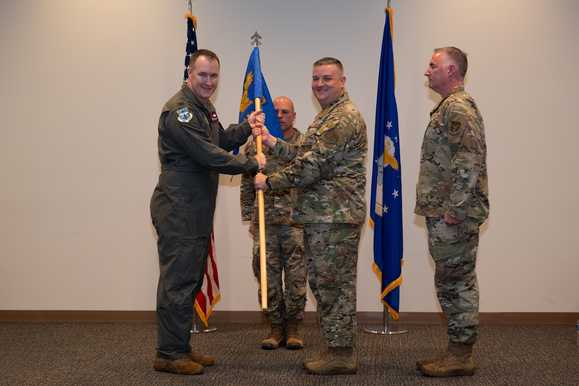 Chief Master Sgt. David Jackson, outgoing 403rd Wing command chief, relinquishes the guidon to Col. Jaret Fish, 403rd Wing commander, during the wing’s first-ever Change of Responsibility ceremony.