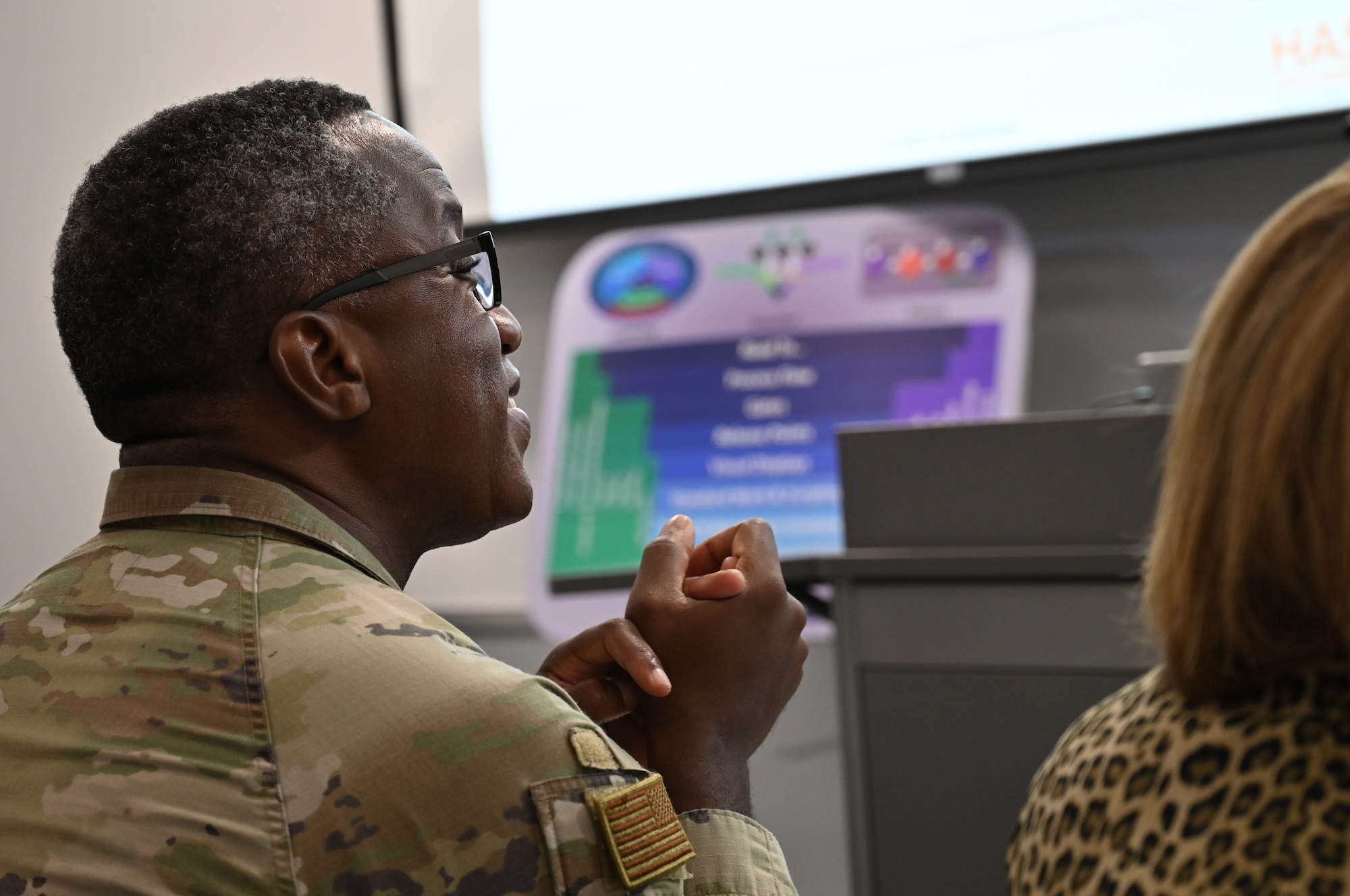 A military general watching a presentation.