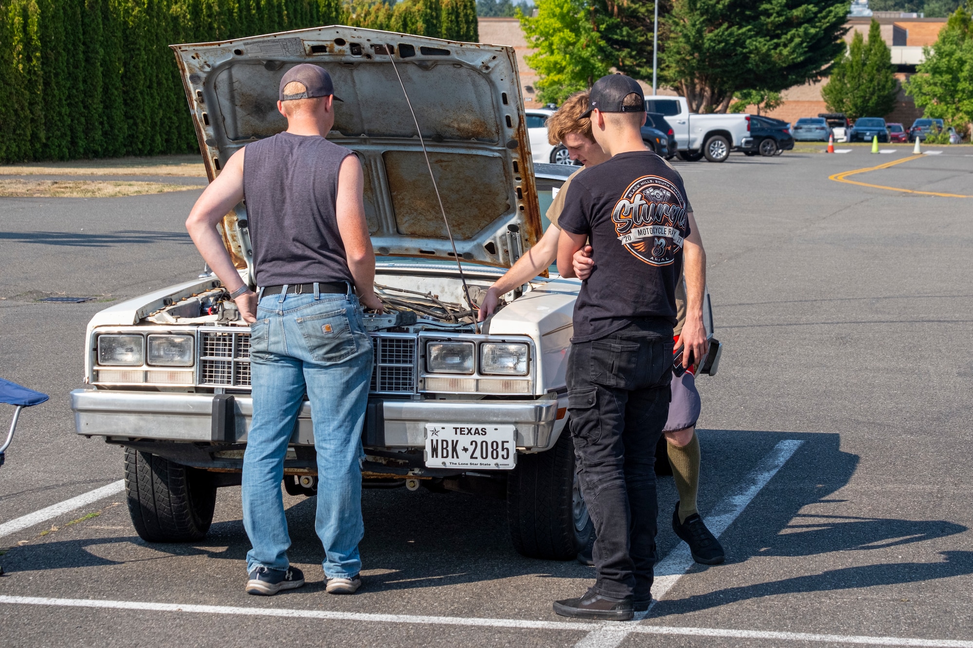 Team McChord Airmen view a car show entry during the 2025 Team McChord Summer Block Party at Joint Base Lewis-McChord, Washington, Aug. 28, 2025.
