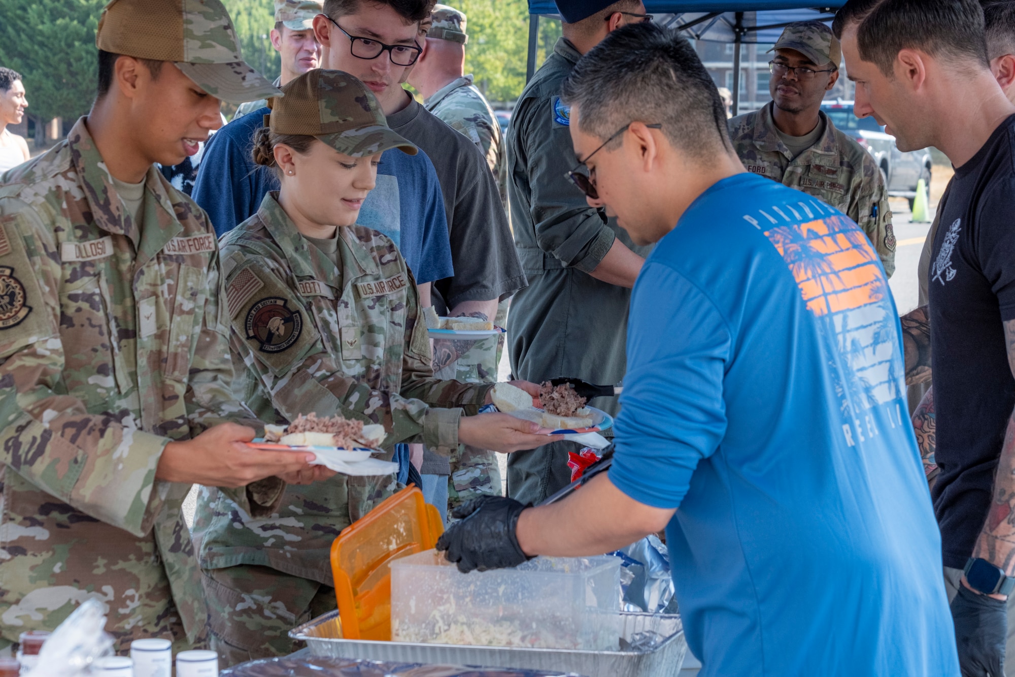 Team McChord Airmen plate pork sliders during the 2025 Team McChord Summer Block Party at Joint Base Lewis-McChord, Washington, Aug. 28, 2025.