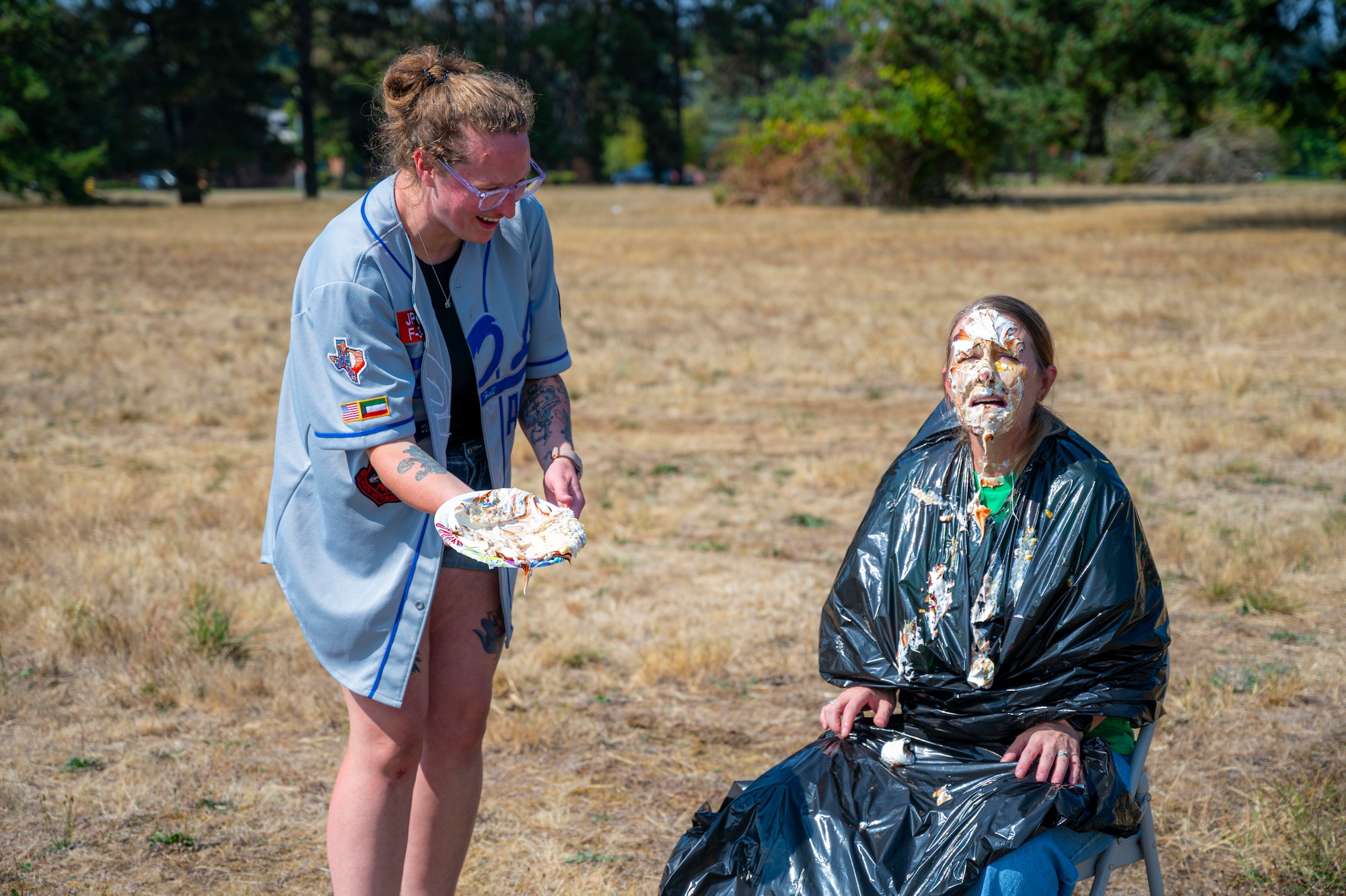 U.S. Air Force Tech. Sgt. Sarah Davidson, 627th Logistics Readiness Squadron fuels quality compliance section chief, delivers a pie to the face of Chief Master Sgt. Kristy Korchak-Campbell, 62d Airlift Wing command chief, during the 2025 Team McChord Summer Block Party at Joint Base Lewis-McChord, Washington, Aug. 28, 2025.