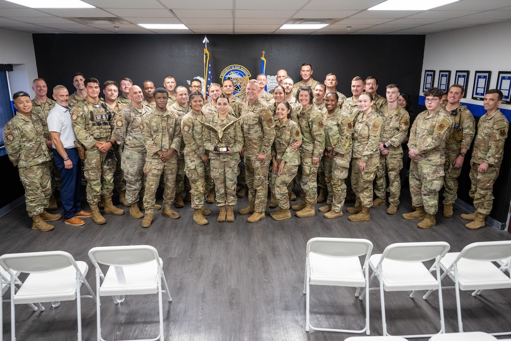 U.S. Air Force 97th Security Forces Squadron (SFS) defenders pose with Chief Master Sgt. Donald S. Gallagher, Security Forces career field manager, at Altus Air Force Base, Oklahoma, Sept. 4, 2025. During Gallagher’s visit, he gave insight about the career field to younger defenders. (U.S. Air Force photo by Airman 1st Class Nathan Langston)