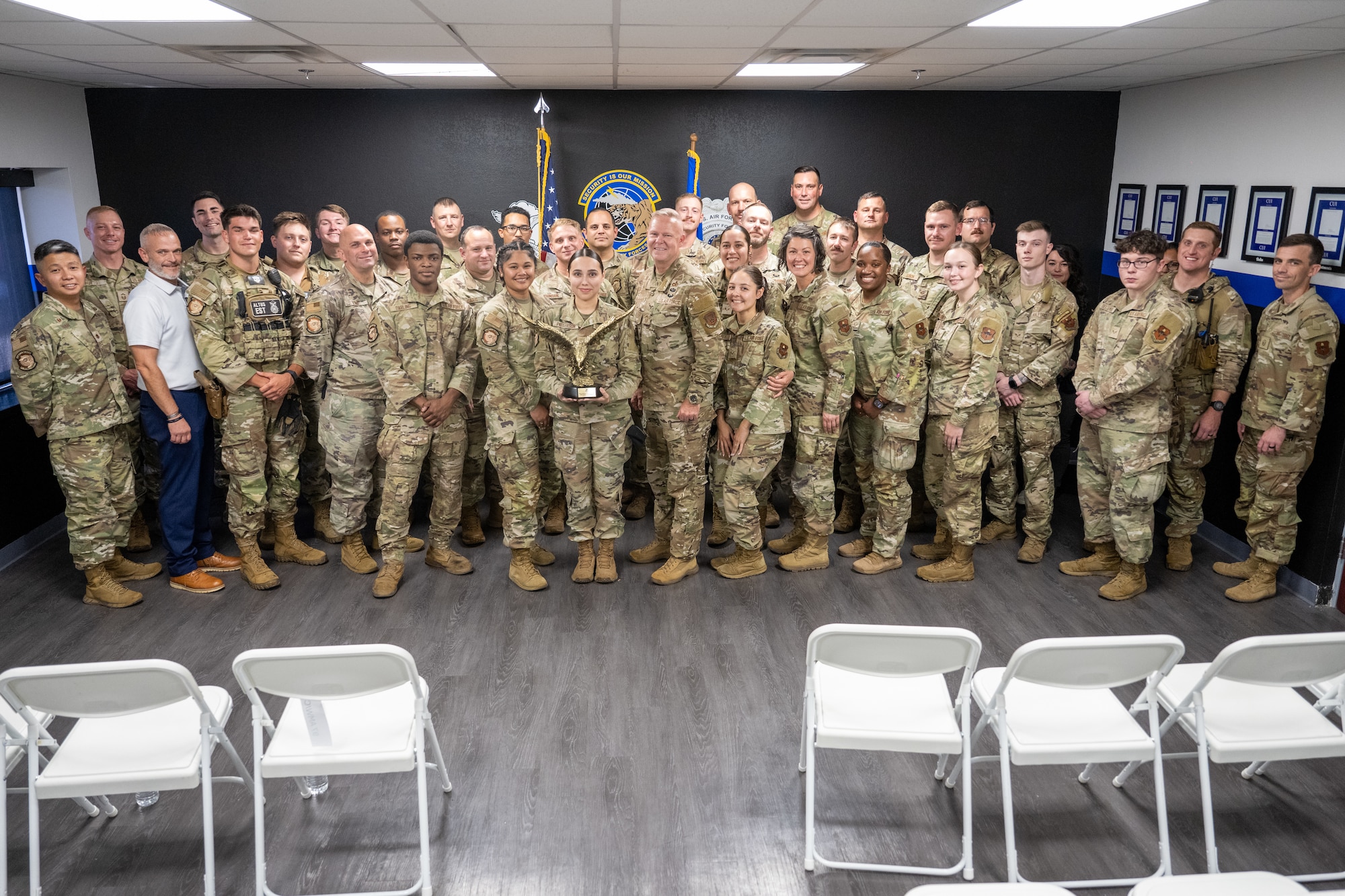 U.S. Air Force 97th Security Forces Squadron (SFS) defenders pose with Chief Master Sgt. Donald S. Gallagher, Security Forces career field manager, at Altus Air Force Base, Oklahoma, Sept. 4, 2025. During Gallagher’s visit, he gave insight about the career field to younger defenders. (U.S. Air Force photo by Airman 1st Class Nathan Langston)
