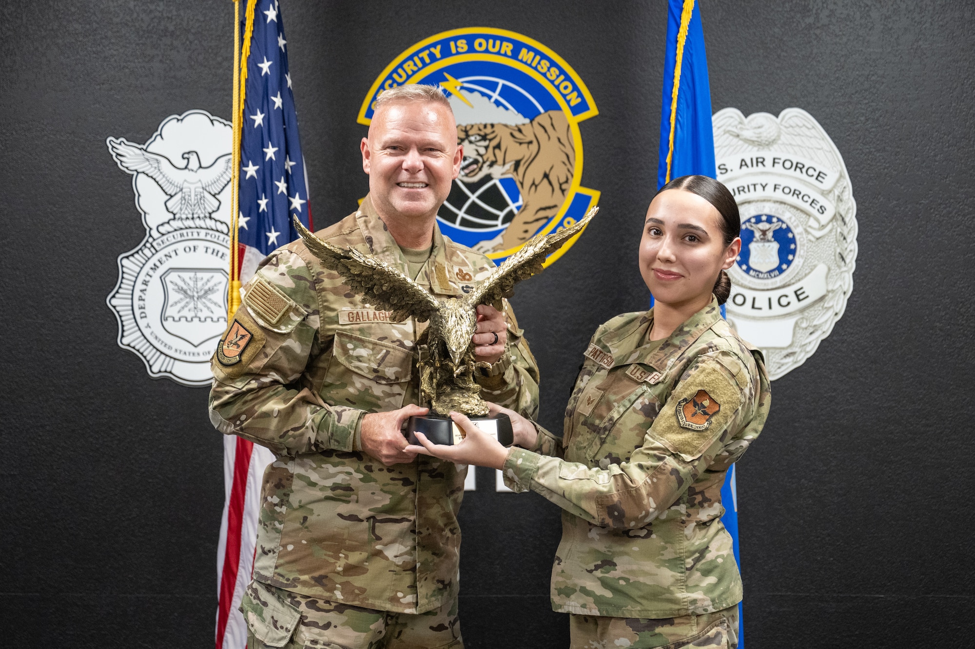 U.S. Air Force Chief Master Sgt. Donald S. Gallagher, Security Forces career field manager, presents the Air Force’s Best Medium-Sized Security Forces Squadron (SFS) award to Senior Airman Paulina Patterson, 97th SFS installation access technician, at Altus Air Force Base, Oklahoma, Sept. 4, 2025. Patterson accepted the award on behalf of the entire 97th SFS. (U.S. Air Force photo by Airman 1st Class Nathan Langston)
