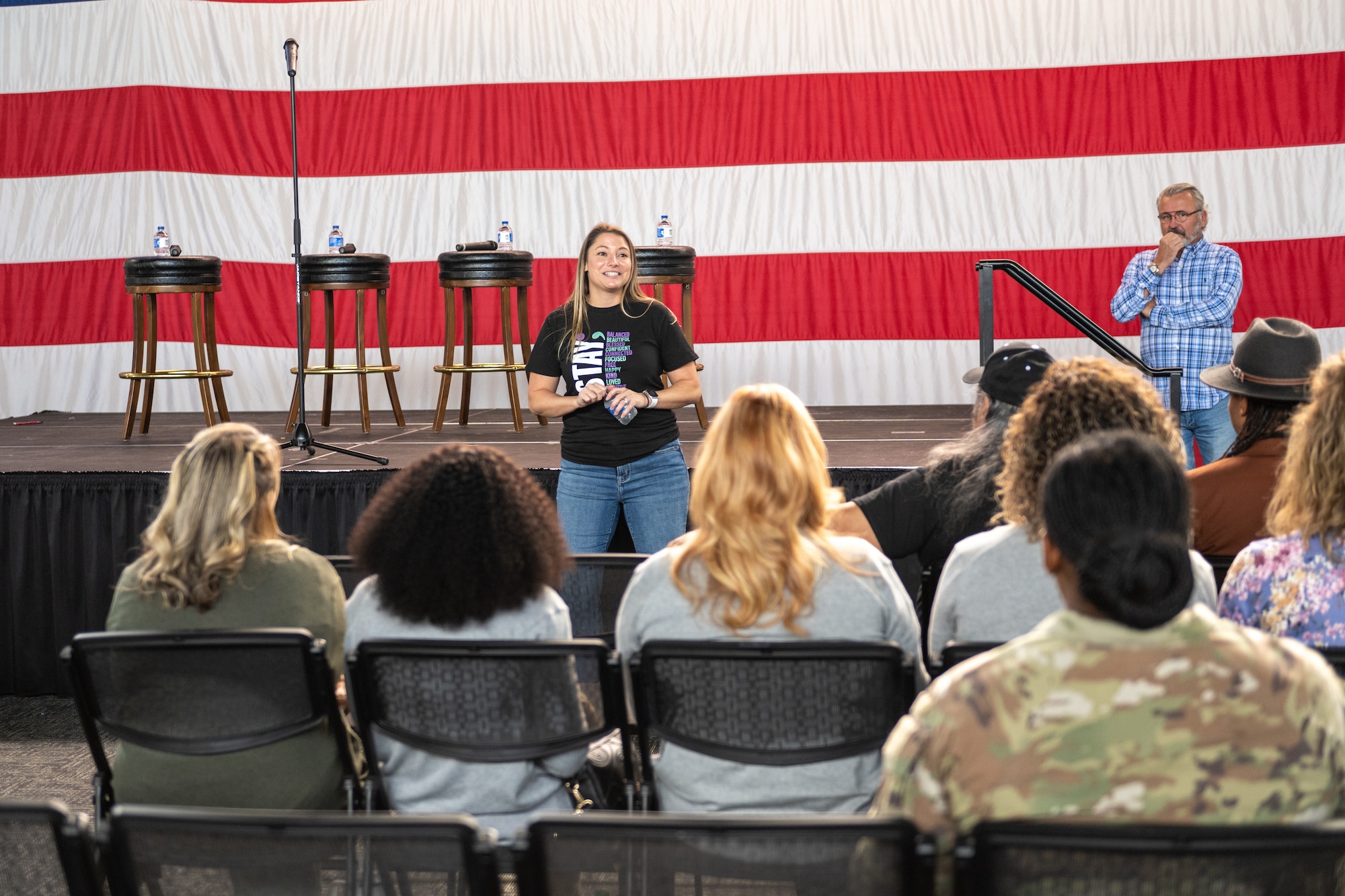 A woman speaks to an audience.