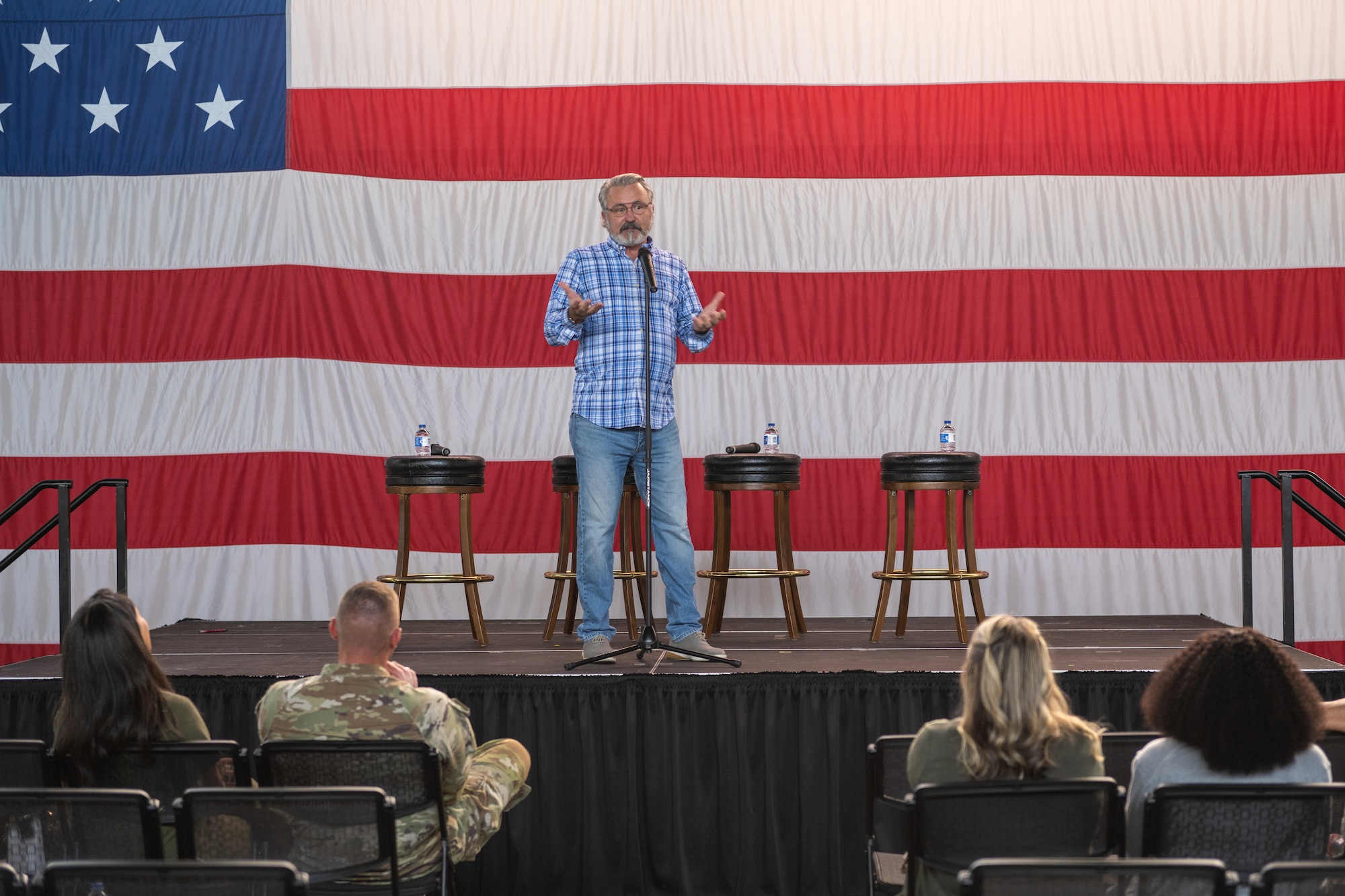 A man stands on stage in front of an audience.