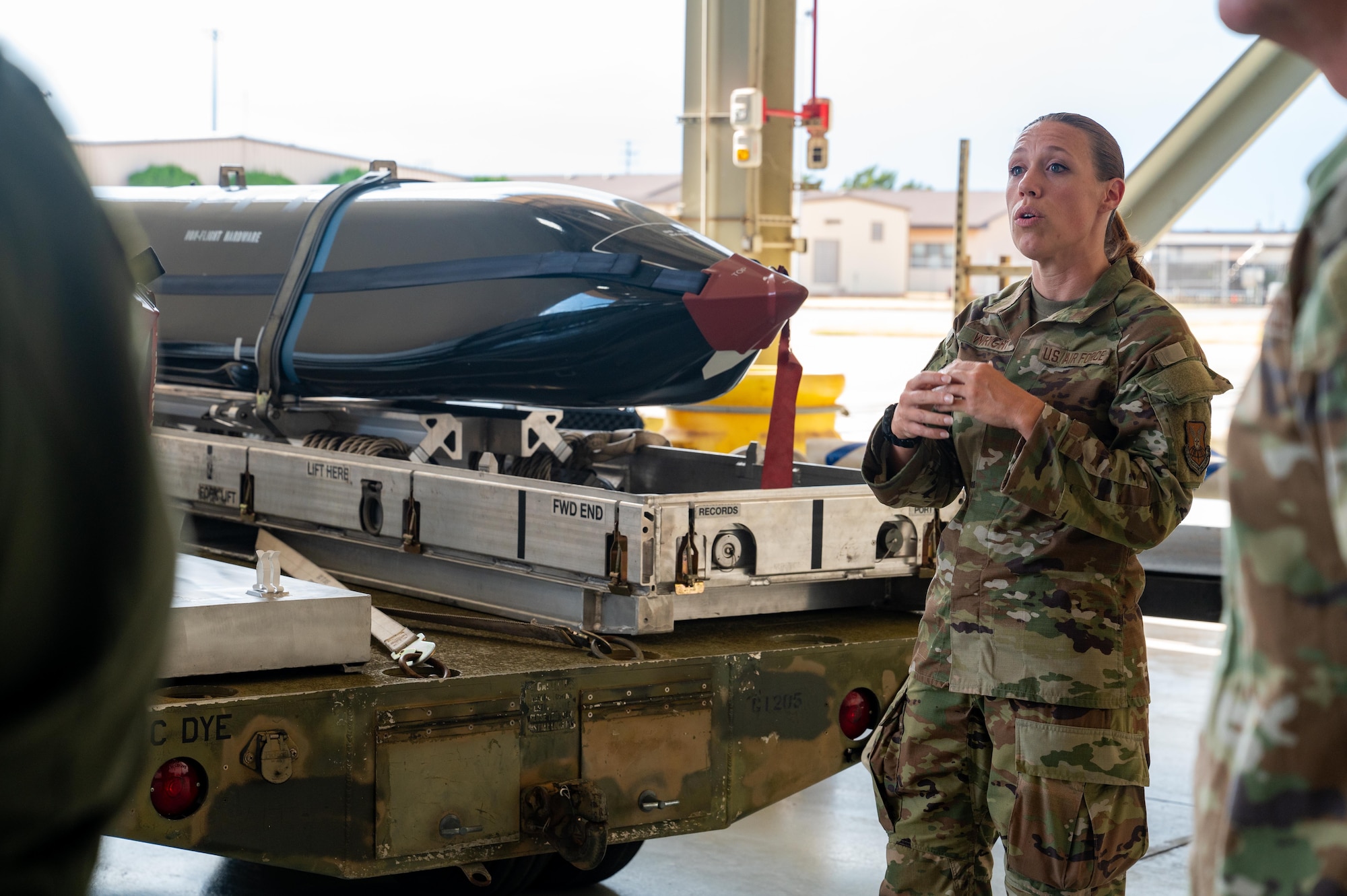 U.S. Air Force Tech. Sgt. Brea Wright, 7th Munitions Squadron senior munitions inspector, explains the capabilities and uses of a Long-Range Anti-Ship Missile to Professional Staff Members from the House China Select Committee during a base tour on Dyess Air Force Base, Texas, Aug. 27, 2025. The LRASM is an air launched cruise missile designed to autonomously identify and engage high-threat maritime targets. (U.S. Air Force photo by Airman 1st Class Adrien Tran)