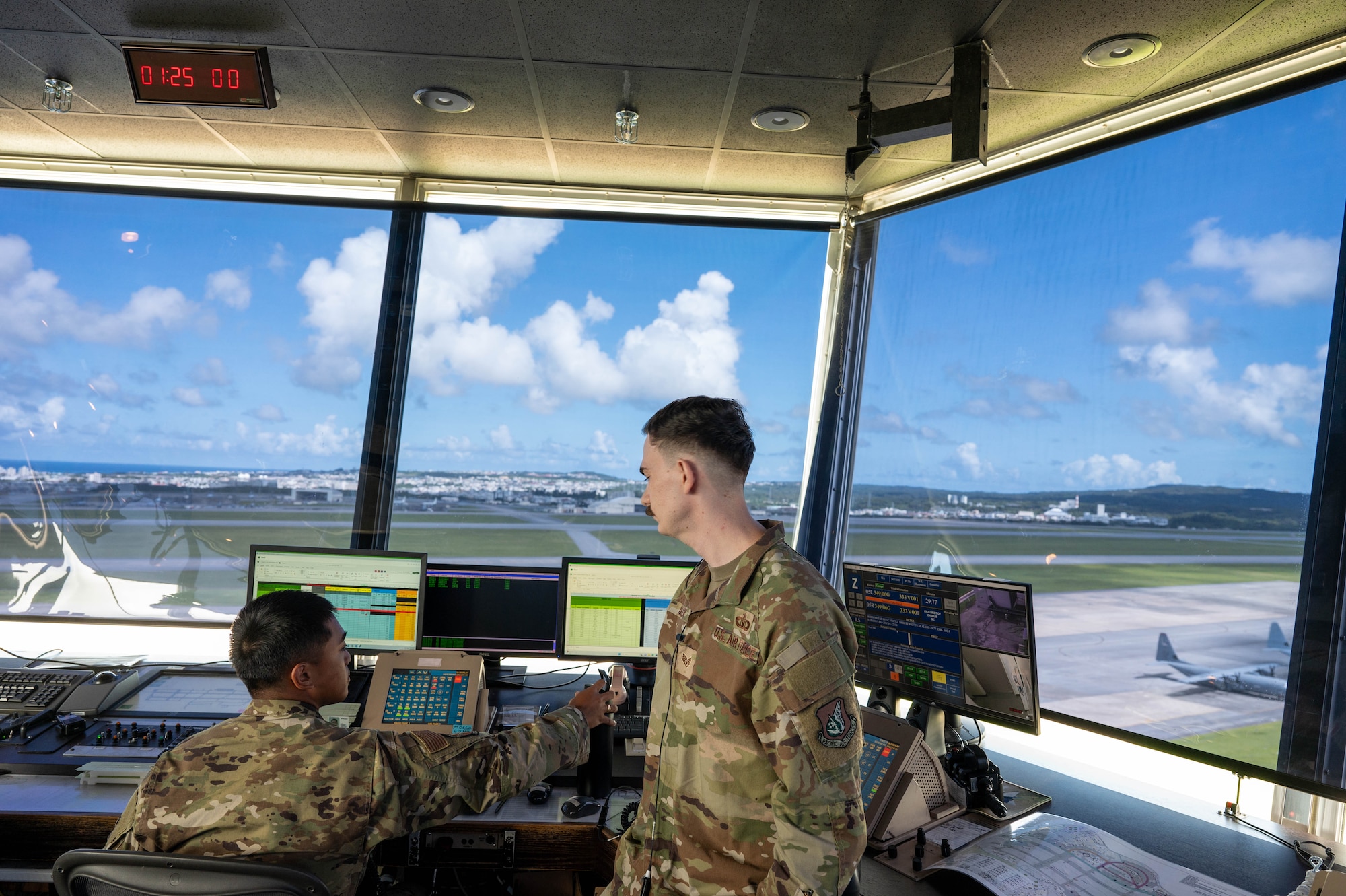 Service members looking over monitors.