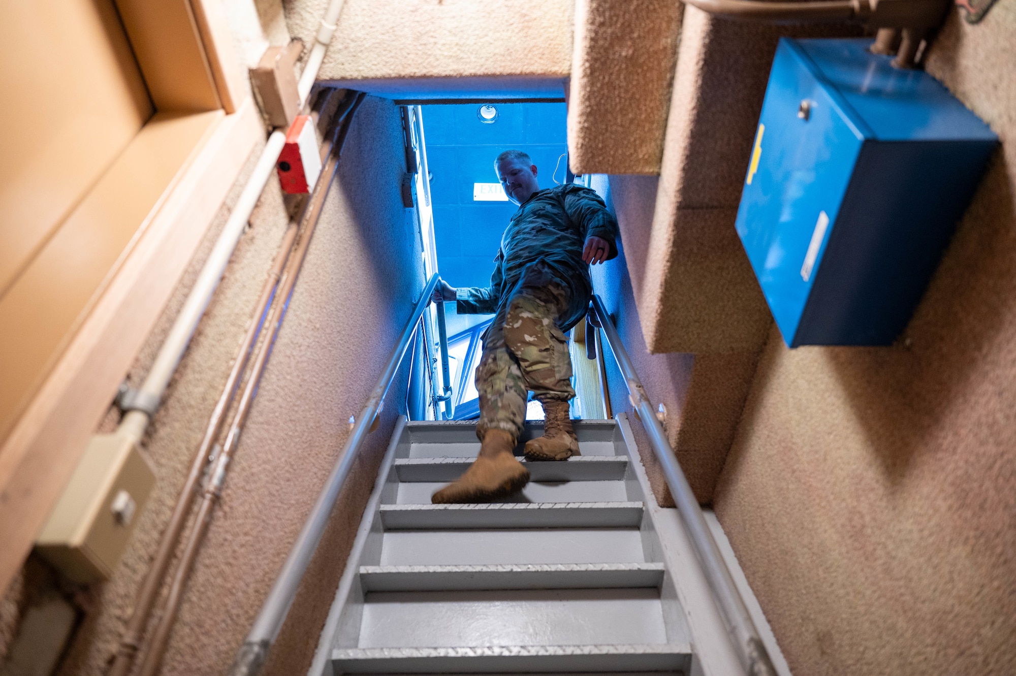 Service member goes down the stairs.