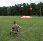 Virginia National Guard Soldiers assigned to the Sandston-based 2nd Battalion, 224th Aviation Regiment, 29th Infantry Division and members of the Fort Pickett Fire and Emergency Services conduct water bucket training using a self-supporting portable water tank Aug. 21, 2025, at Fort Pickett, Virginia. The training is the first time the aviators have trained filling water buckets from the 14,000-gallon tank, which can be deployed in areas without a nearby pond or lake. Aviation assets can support firefighting efforts with the use of water buckets, which require periodic training for flight crews in order to ensure equipment proficiency. Read more about the 2-224th at https://vngpao.info/mrxrkv3m.