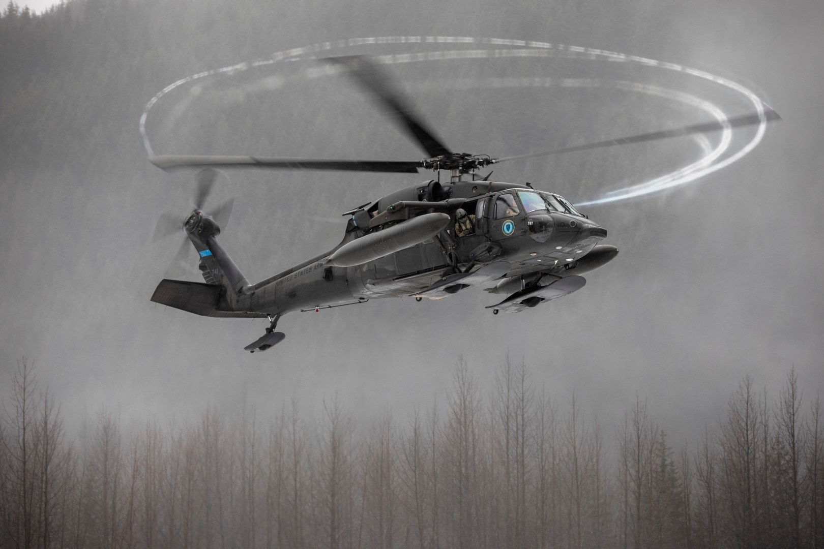 An Alaska Army National Guard UH-60L Black Hawk helicopter assigned to A Company, 1-168th General Support Aviation Battalion approaches the Herbert Glacier riverbed while conducting flight operations near Juneau, Alaska, Jan. 24, 2025.
