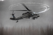 An Alaska Army National Guard UH-60L Black Hawk helicopter assigned to A Company, 1-168th General Support Aviation Battalion approaches the Herbert Glacier riverbed while conducting flight operations near Juneau, Alaska, Jan. 24, 2025.