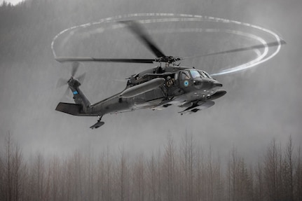An Alaska Army National Guard UH-60L Black Hawk helicopter assigned to A Company, 1-168th General Support Aviation Battalion approaches the Herbert Glacier riverbed while conducting flight operations near Juneau, Alaska, Jan. 24, 2025.