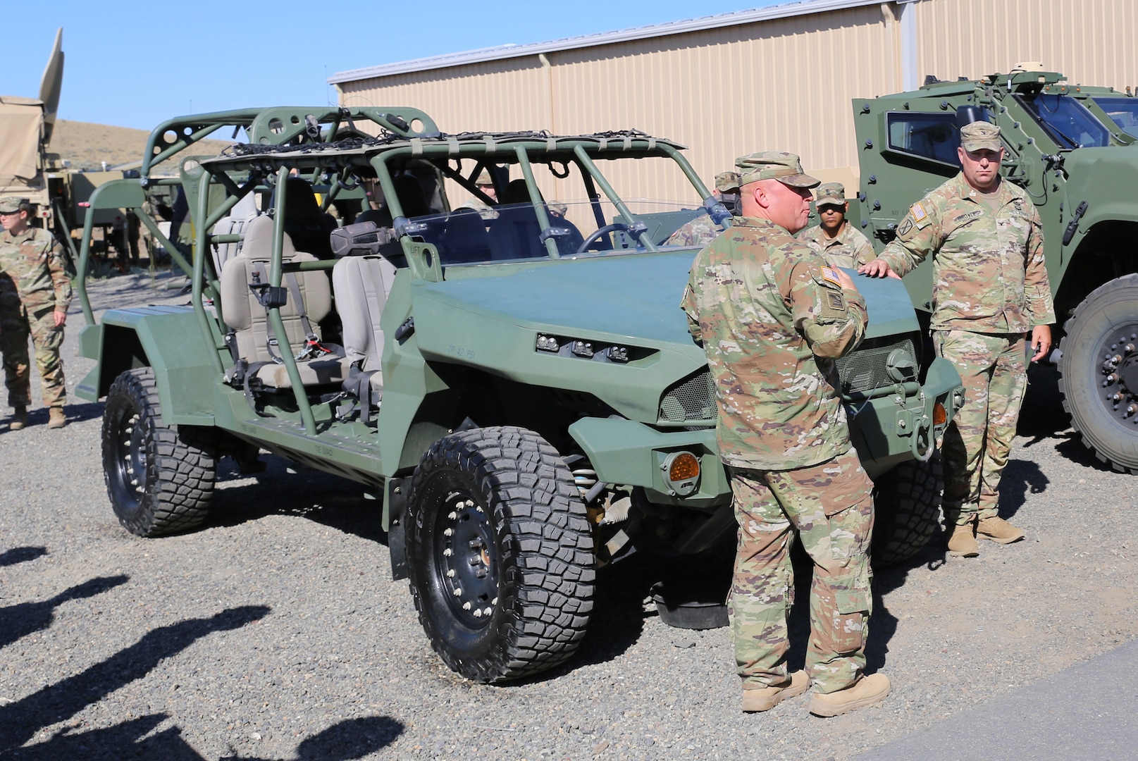 Col. Craig Broyles, commander, 81st Stryker Brigade Combat Team, talks about the Infantry Squad Vehicle with visitors during Exercise Raven Focus at the Yakima Training Center, July 17, 2025.