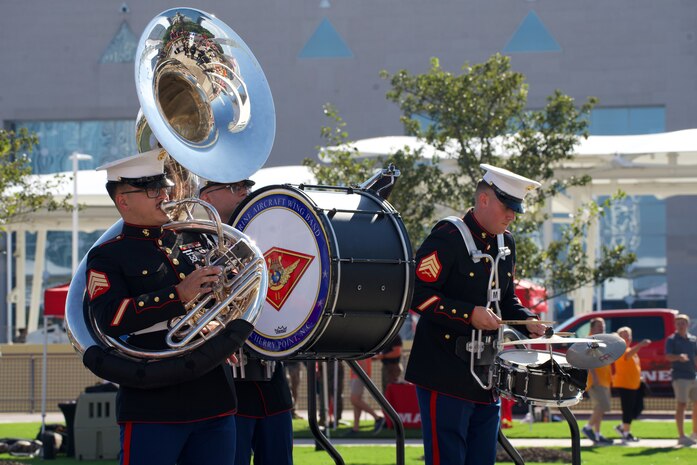 U.S. Marine Corps Sgt. Mathew Hale, (left) a tuba instrumentalist, Cpl. Zachary Haugland, (center) percussion instrumentalist, and Sgt. Peyton Scott, a percussion instrumentalist, with the 2nd Marine Aircraft Wing Band, brass band, assigned to Special Purpose Marine Air-Ground Task Force-250 perform at the static display during Marine Week Atlanta, Aug. 30, 2025. Marines stationed across the globe commemorate the 250th anniversary of the Marine Corps, honoring a distinguished legacy of service, sacrifice, and unwavering fidelity to both the nation and the Corps. (U.S. Marine Corps photo by Staff Sgt. Matthew Booth)