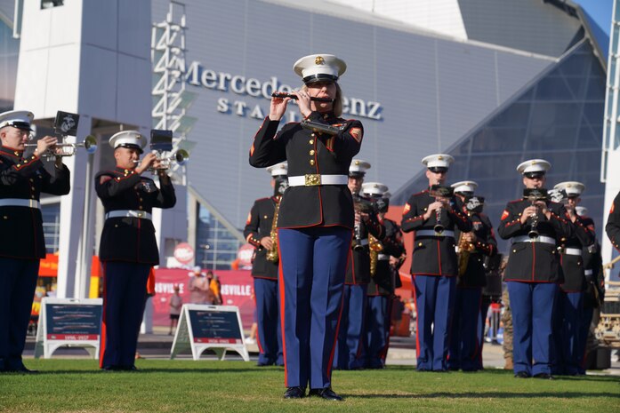 U.S. Marine Corps Staff Sgt. Meggan Peel, a flute instrumentalist with the 2nd Marine Aircraft Wing Band, assigned to Special Purpose Marine Air-Ground Task Force-250 performs at the static display during Marine Week Atlanta, Aug. 30, 2025. Marines stationed across the globe commemorate the 250th anniversary of the Marine Corps, honoring a distinguished legacy of service, sacrifice, and unwavering fidelity to both the nation and the Corps. (U.S. Marine Corps photo by Staff Sgt. Matthew Booth)