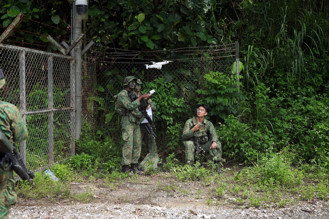 Singapore Guardsmen with 3rd Battalion Singapore Guards, 7th Singapore Infantry Brigade, flys a Parrot Amari AI drone for an unmanned aerial systems flight during the field training exercise as part of Valiant Mark 25 at SAFTI City training facility, Singapore, March 26, 2025. SAFTI City is one of the largest and most technologically advanced urban training facilities in the world and the premier urban training facility in Southeast Asia. Valiant Mark is an annual, bilateral training exercise designed to enhance interoperability, build mutual defense capabilities, and strengthen military-to-military relationships between the U.S. Marine Corps and Singapore Armed Forces(U.S. Marine Corps photo by Cpl. Tyler Wilson)