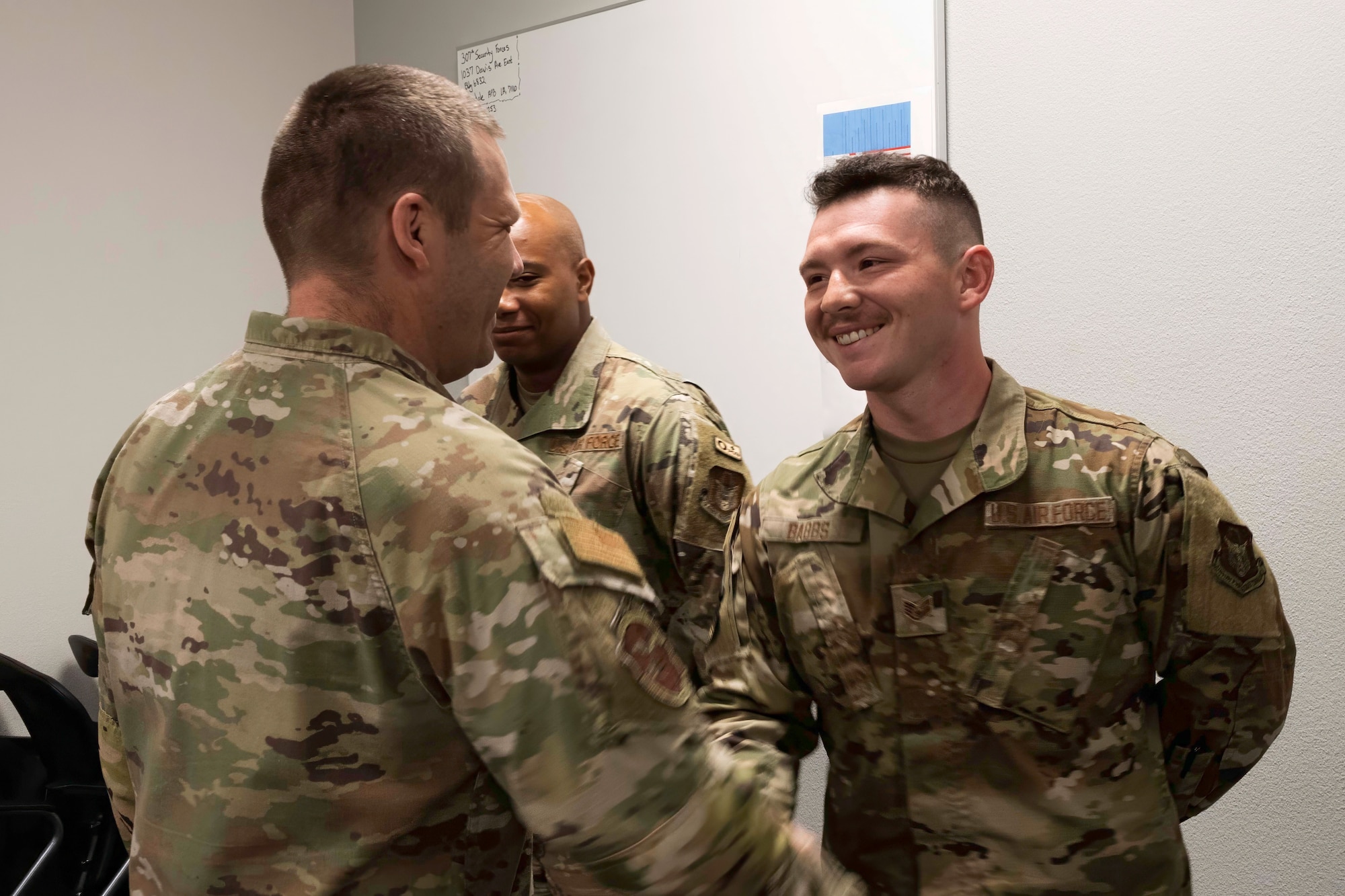 U.S. Air Force Chief Master Sgt. Michael Roberts, Air Force Reserve Command Security Forces senior enlisted leader, coins Staff Sgt. Gage Babbs