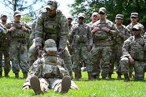 Tech. Sgt. Anfernee Morgan, a member of the 307th Security Forces Squadron at Barksdale Air Force Base, Louisiana, and member of the Integrated defense Leadership Course cadre, demonstrates methods for moving wounded wingmen during tactical combat casualty care training