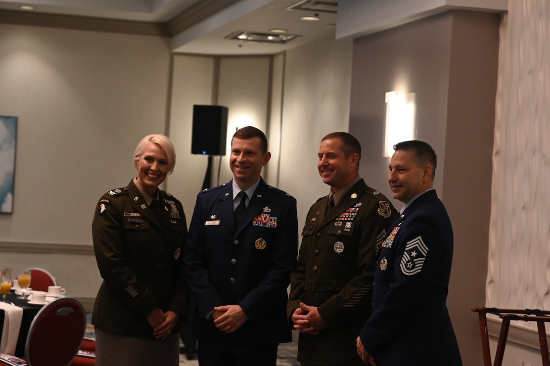 Four service members pose for a photo.