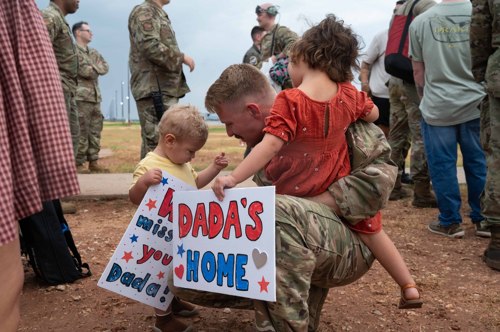 A U.S. Air Force Airman assigned to the 317th Airlift Wing embraces his family after returning from a deployment at Dyess Air Force Base, Texas, Sept. 5, 2025.  While deployed, the 40th Airlift Squadron played a critical role in supporting global mobility missions, flying the C-130J Super Hercules in support of joint operations, tactical airlift, and humanitarian efforts.  (U.S. Air Force photo by Airman William Neal)