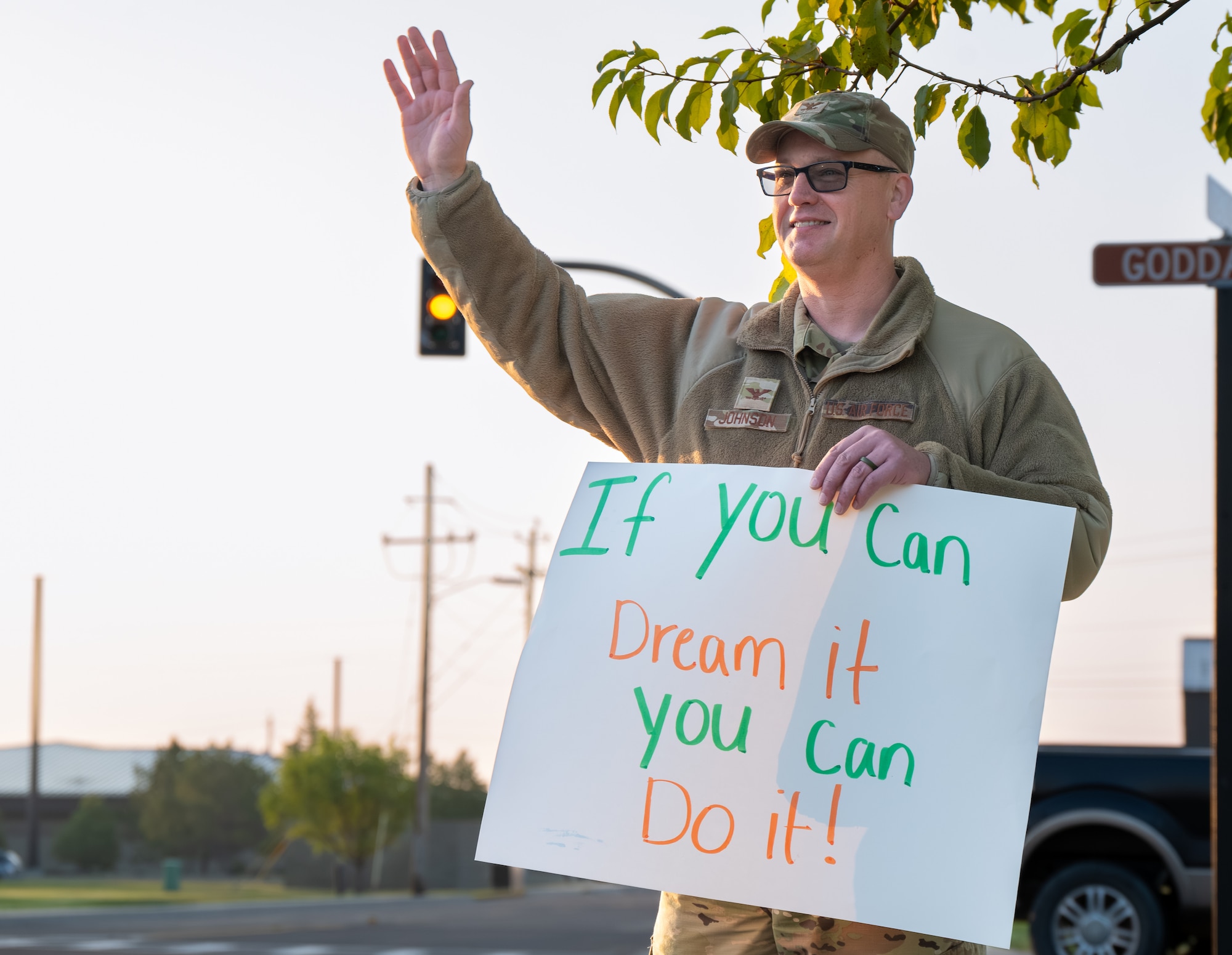 U.S. Air Force Colonel hold positive sign and waves