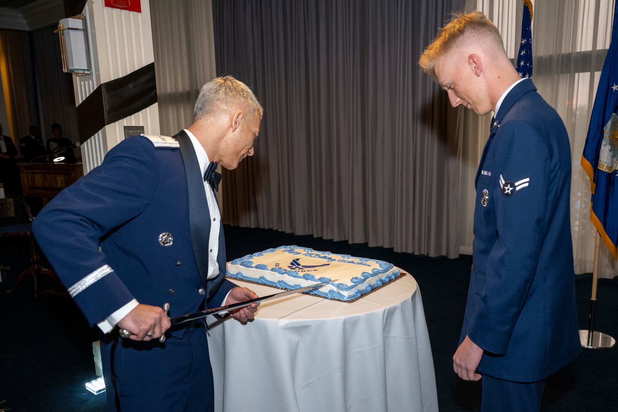 U.S. Air Force Brig. Gen. Jason Lennen, director of policy and resources at the Office of the Surgeon General, cuts the Air Force birthday cake with Airman 1st Class Tobiyah Nash, a ceremonial guardsman with the U.S. Air Force Honor Guard Memorial Colors, during the Joint Base Anacostia-Bolling U.S. Air Force 78th Birthday Ball, Washington, D.C., Sept. 5, 2025. It is traditional for the most senior and most junior Airmen in attendance to cut the cake, symbolizing the passing of legacy from one generation to the next. (U.S. Air Force photo by Hayden Hallman)