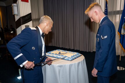 U.S. Air Force Brig. Gen. Jason Lennen, director of policy and resources at the Office of the Surgeon General, cuts the Air Force birthday cake with Airman 1st Class Tobiyah Nash, a ceremonial guardsman with the U.S. Air Force Honor Guard Memorial Colors, during the Joint Base Anacostia-Bolling U.S. Air Force 78th Birthday Ball, Washington, D.C., Sept. 5, 2025. It is traditional for the most senior and most junior Airmen in attendance to cut the cake, symbolizing the passing of legacy from one generation to the next. (U.S. Air Force photo by Hayden Hallman)