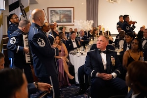 U.S. Air Force Col. James A. Hudnell, deputy commander of Joint Base Anacostia-Bolling and the 11th Wing, center right, listens to The U.S. Air Force Band’s Strolling Strings during the JBAB U.S. Air Force 78th Birthday Ball, Washington, D.C., Sept. 5, 2025. The Strolling Strings provided a modern touch on classical entertainment, inspiring listeners and honoring Air Force heritage. (U.S. Air Force photo by Hayden Hallman)